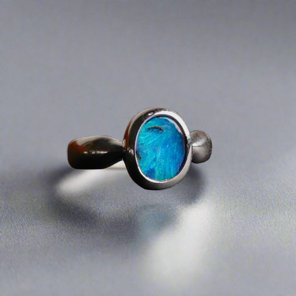 This Vibrant Sterling Silver Boulder Opal Ring showcases stunning ocean blue hues, making it a truly eye-catching accessory. Crafted with high-quality sterling silver and featuring a boulder opal, this ring is both beautiful and durable. Elevate any outfit with this striking piece of jewelry.

Origin- Ethically mined in Queensland Australia

Opal Weight- 1.9ct

Setting- Sterling Silver

Size- 6 1/2us

Crafted By Passionate Australian Artisans