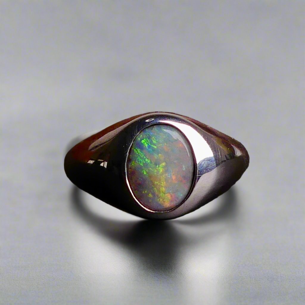Expertly crafted with solid sterling silver and showcasing a beautiful and vibrant boulder opal, this ring is a stunning addition to any jewelry collection. The unique combination of metal and gemstone offers a timeless and elegant look, perfect for any occasion. Elevate your style with this exquisite piece

Opal Weight- 2ct

Setting- Sterling Silver Bezel Set

Size- 7us

Crafted By Australian Artisans