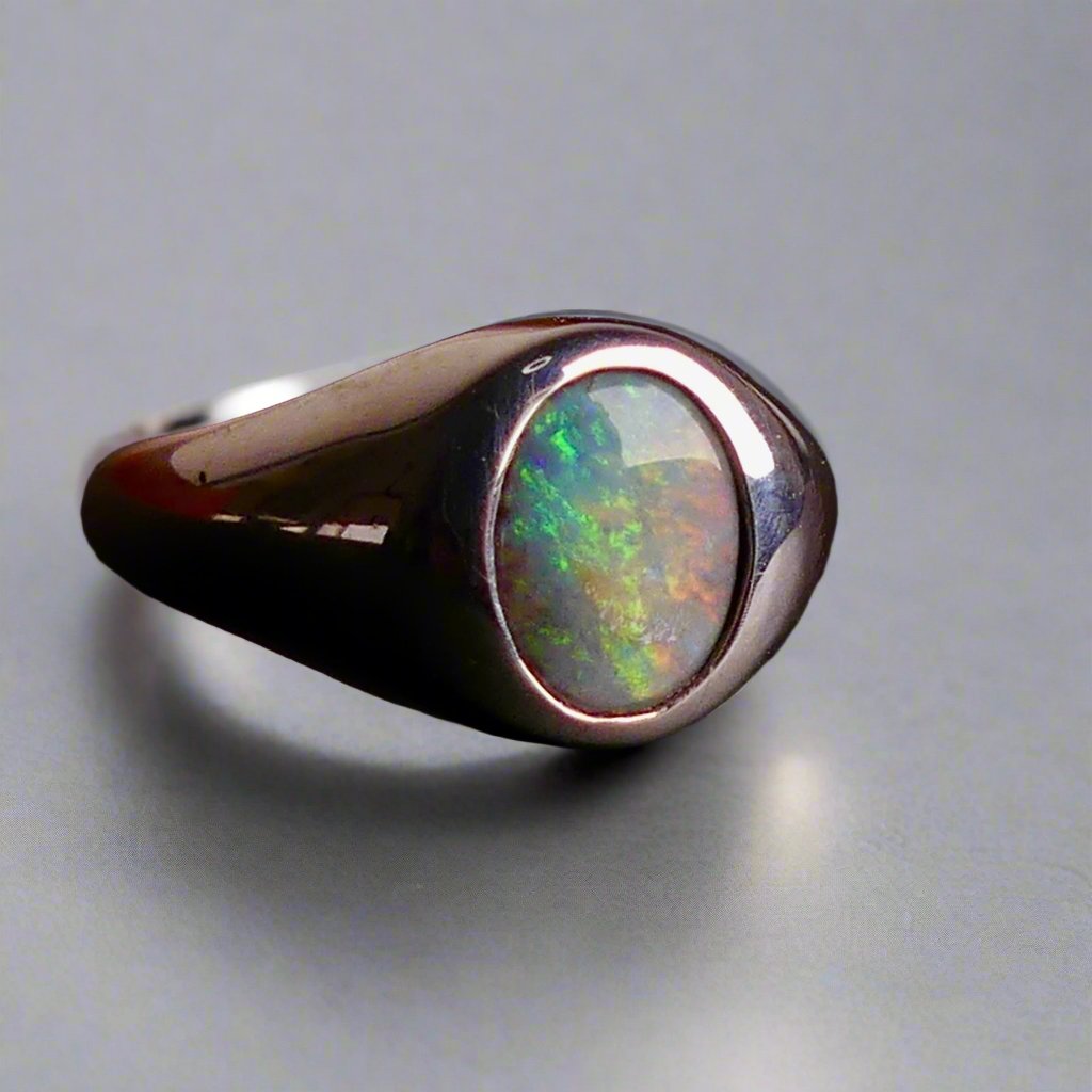 Expertly crafted with solid sterling silver and showcasing a beautiful and vibrant boulder opal, this ring is a stunning addition to any jewelry collection. The unique combination of metal and gemstone offers a timeless and elegant look, perfect for any occasion. Elevate your style with this exquisite piece

Opal Weight- 2ct

Setting- Sterling Silver Bezel Set

Size- 7us

Crafted By Australian Artisans
