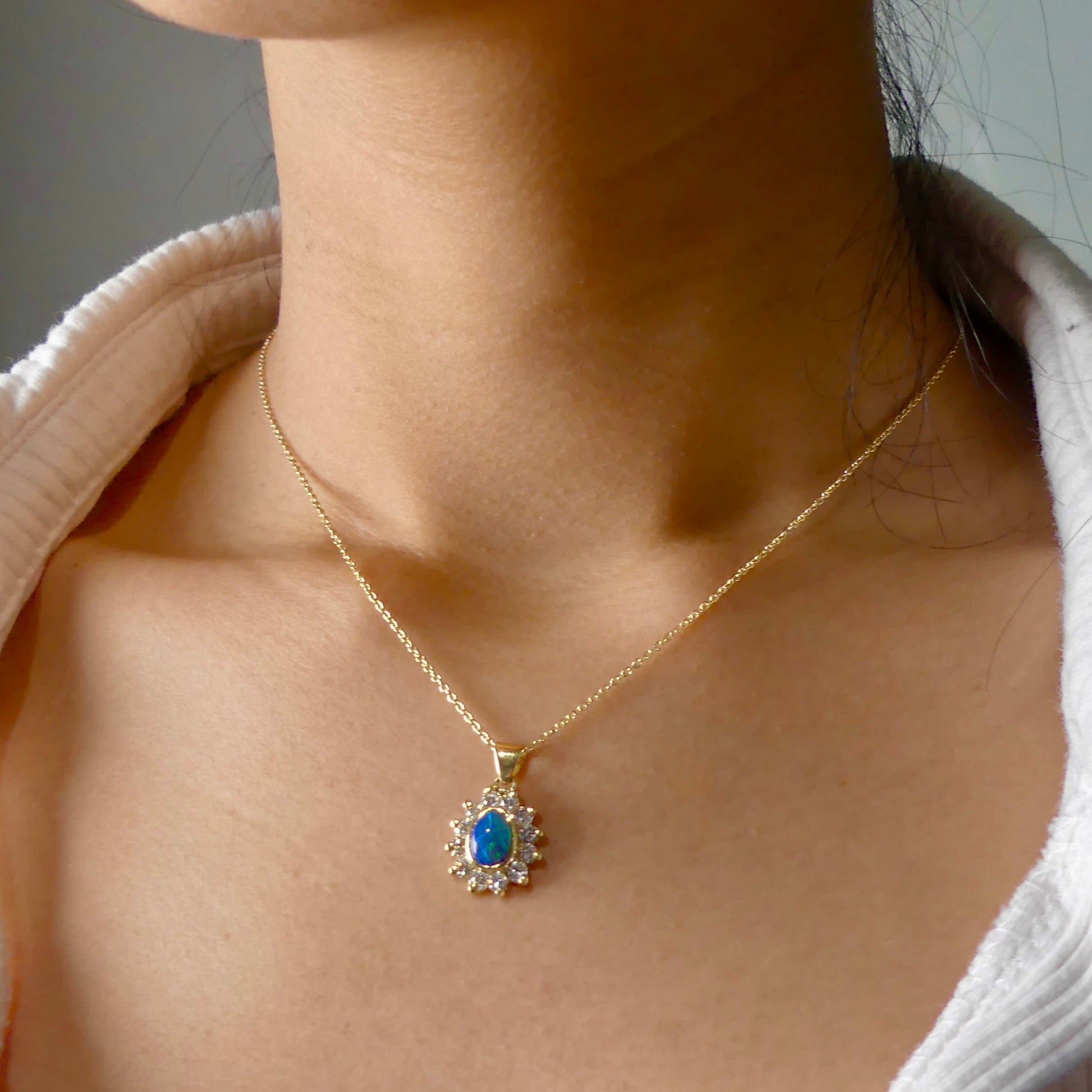 Experience the captivating allure of this handcrafted 18K Yellow Gold Opal &amp; Diamond Halo Pendant. With a striking Lightning Ridge opal showcasing a rare and sought-after script pattern consisting of blue, green, and gold tones, complemented by radiant diamonds, this necklace is a sophisticated and essential piece for any collection.

Origin- Lightning Ridge Australia

Opal Weight- 1ct Australian Lightning Ridge Semi Black Opal

Setting- 18k Yellow Gold Bezel set, claw set Diamond Halo