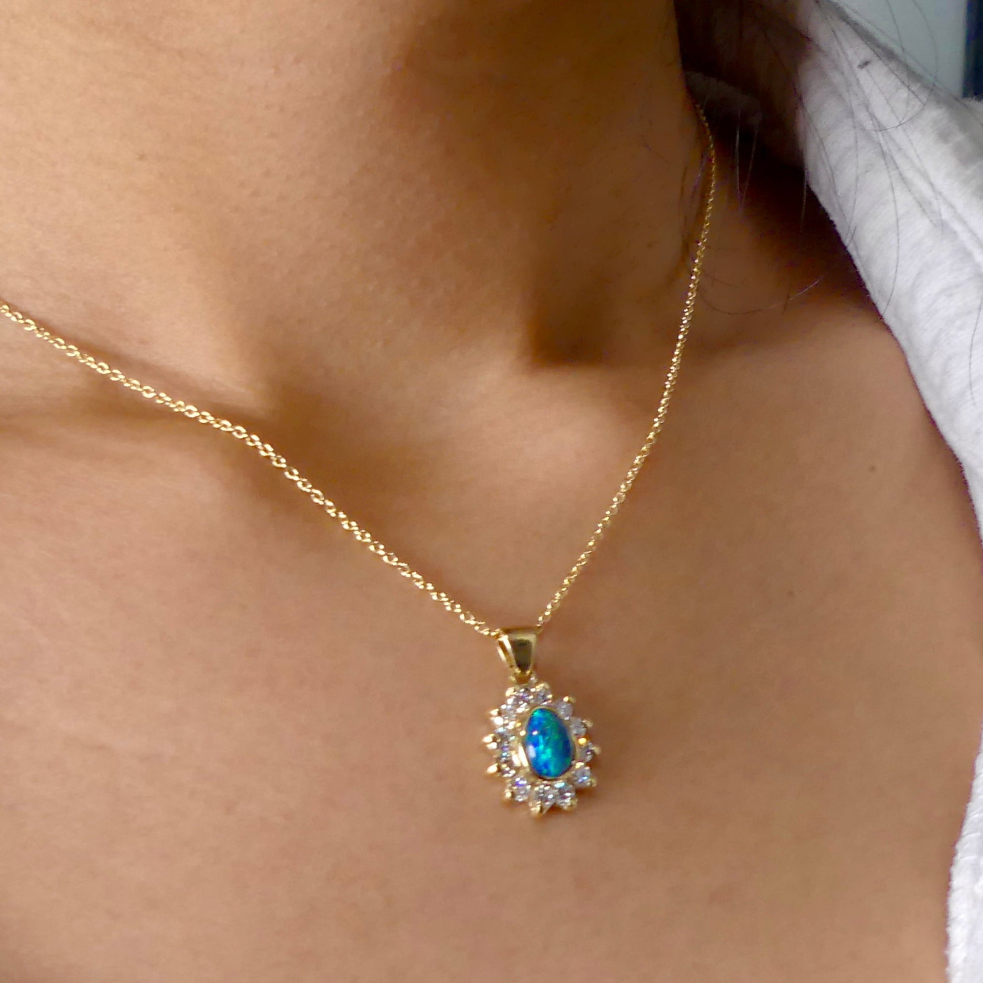 Experience the captivating allure of this handcrafted 18K Yellow Gold Opal &amp; Diamond Halo Pendant. With a striking Lightning Ridge opal showcasing a rare and sought-after script pattern consisting of blue, green, and gold tones, complemented by radiant diamonds, this necklace is a sophisticated and essential piece for any collection.

Origin- Lightning Ridge Australia

Opal Weight- 1ct Australian Lightning Ridge Semi Black Opal

Setting- 18k Yellow Gold Bezel set, claw set Diamond Halo