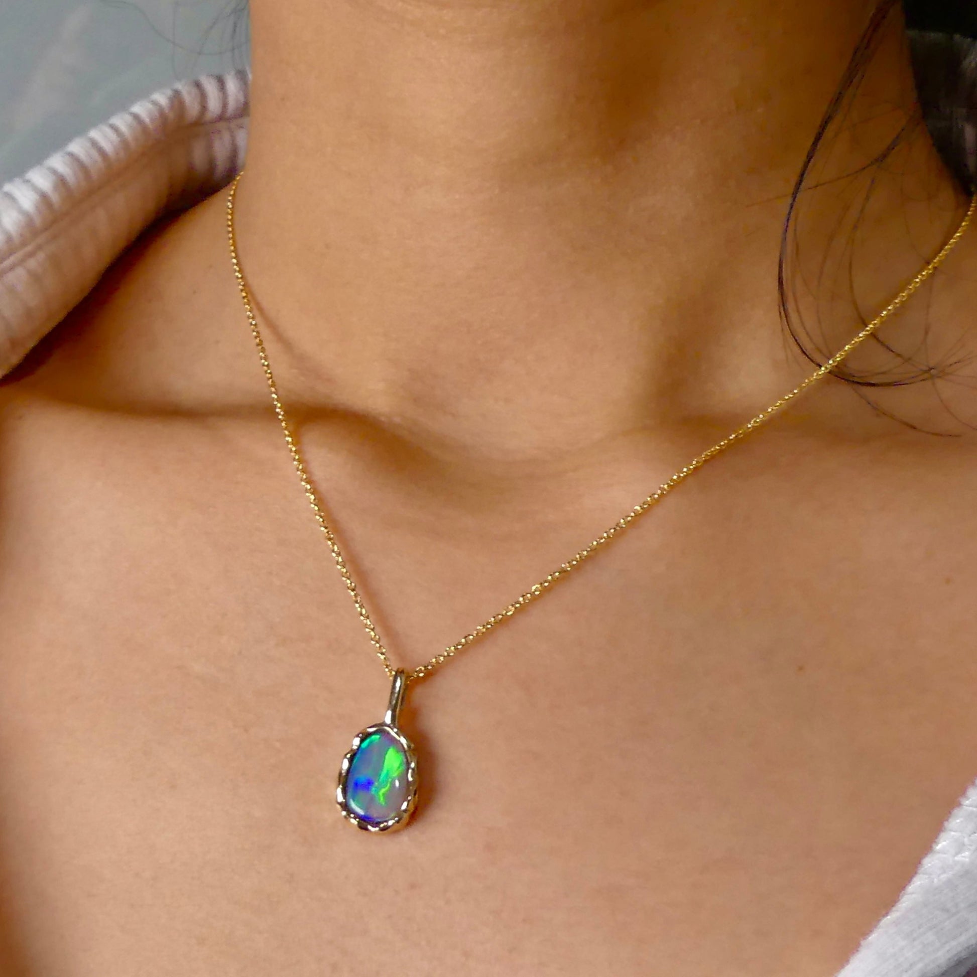Uncover the stunning Australian opal beauty of our 9k Gold Lightning Ridge Opal pendant. Featuring a unique lava-inspired handcrafted design with green, blue, and gold tones, this high-quality masterpiece is a lasting addition to your collection.

Origin- Ethically Mined in Lightning Ridge Australia

Opal Weight- 1.5ct Lightning Ridge Crystal Opal

Setting- 9k Gold Lava inspired custom design

Chain- 9k Gold Cable Chain 45cm in Length

Treatments- None- 100% Solid Australian Opal
