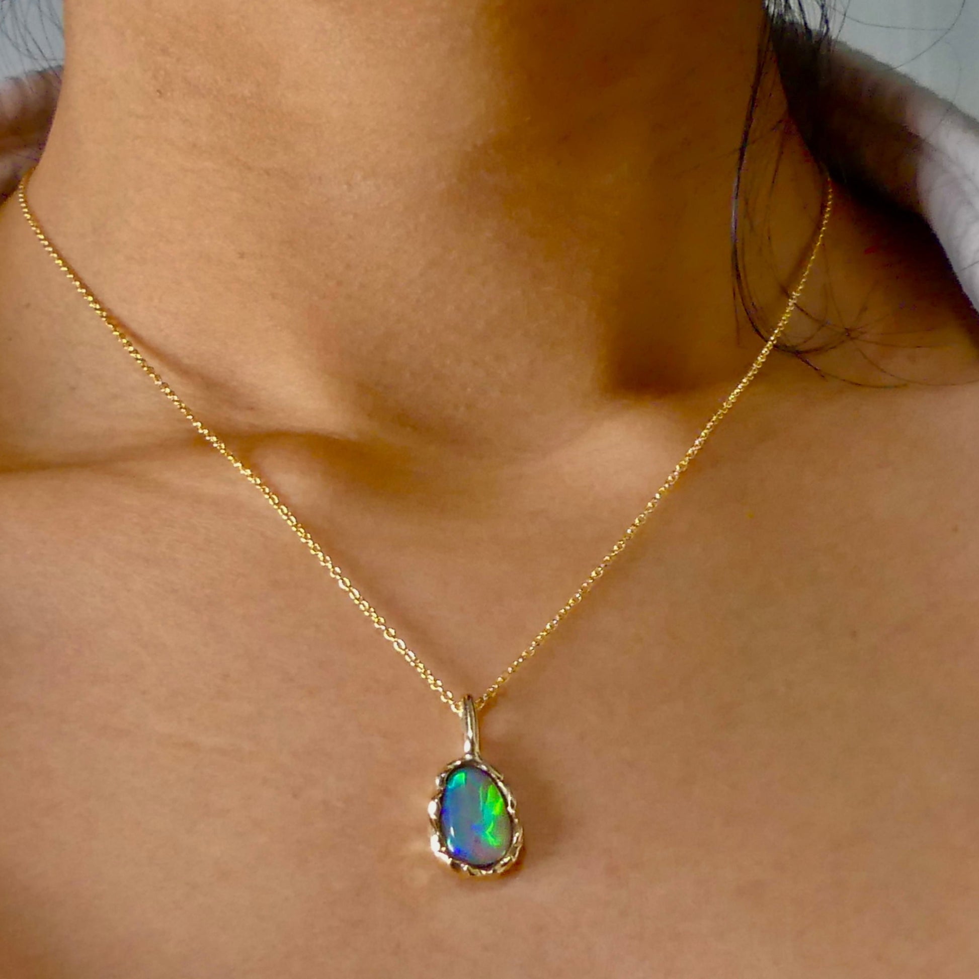 Uncover the stunning Australian opal beauty of our 9k Gold Lightning Ridge Opal pendant. Featuring a unique lava-inspired handcrafted design with green, blue, and gold tones, this high-quality masterpiece is a lasting addition to your collection.

Origin- Ethically Mined in Lightning Ridge Australia

Opal Weight- 1.5ct Lightning Ridge Crystal Opal

Setting- 9k Gold Lava inspired custom design

Chain- 9k Gold Cable Chain 45cm in Length

Treatments- None- 100% Solid Australian Opal
