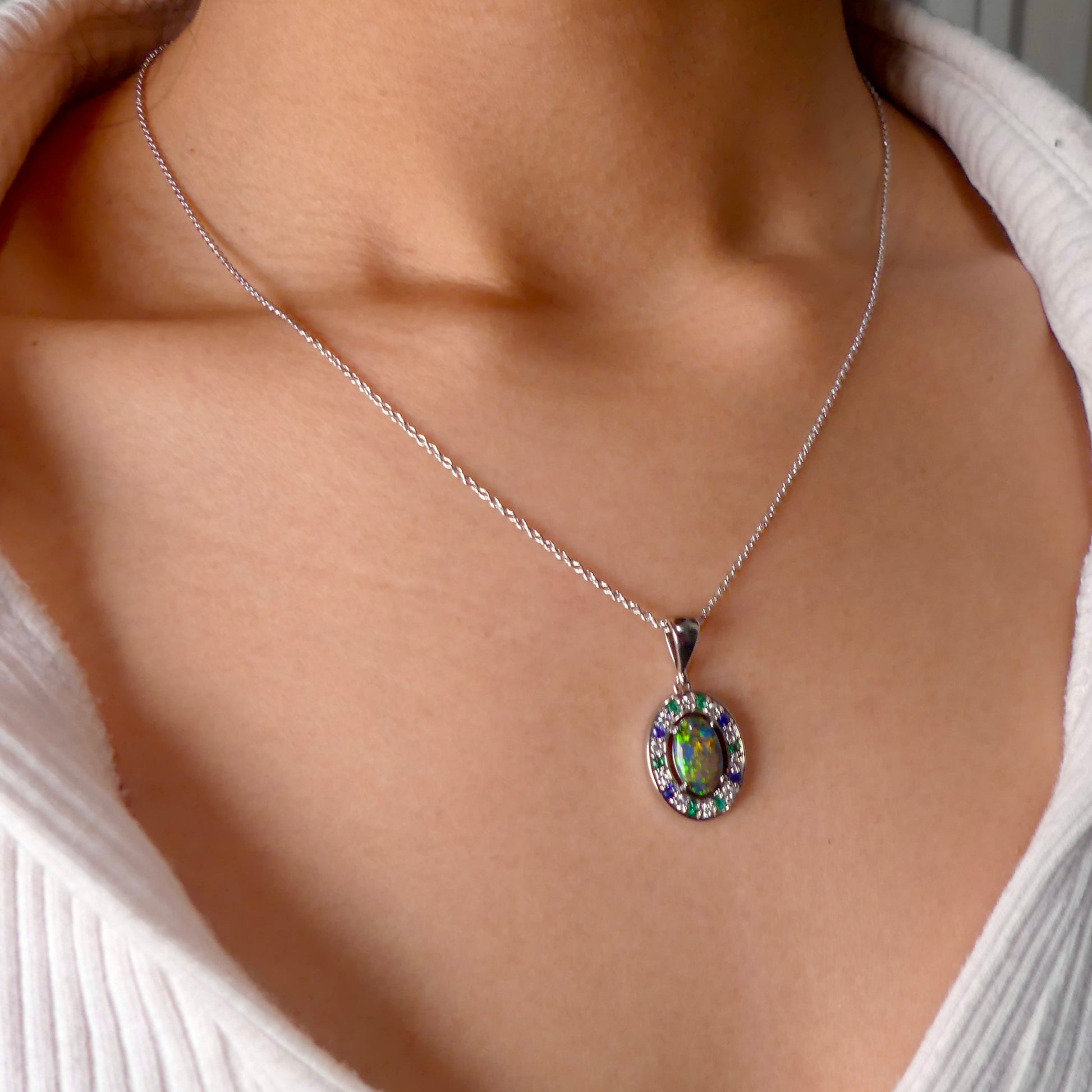 Lightning Ridge Australian black opal with strong, highly prized colors of reds, orange, and yellows is undoubtedly a remarkable gemstone. Expertly crafted from 18k white gold, this pendant showcases the mesmerizing beauty of an Australian black opal, surrounded by sparkling diamonds, emeralds, and sapphires. Exquisite in design and quality, this pendant is a luxurious addition to any jewelry collection. Elevate your style with this stunning piece.

Opal Weight- 1.1ct

Body Tone- N1 Australian Black