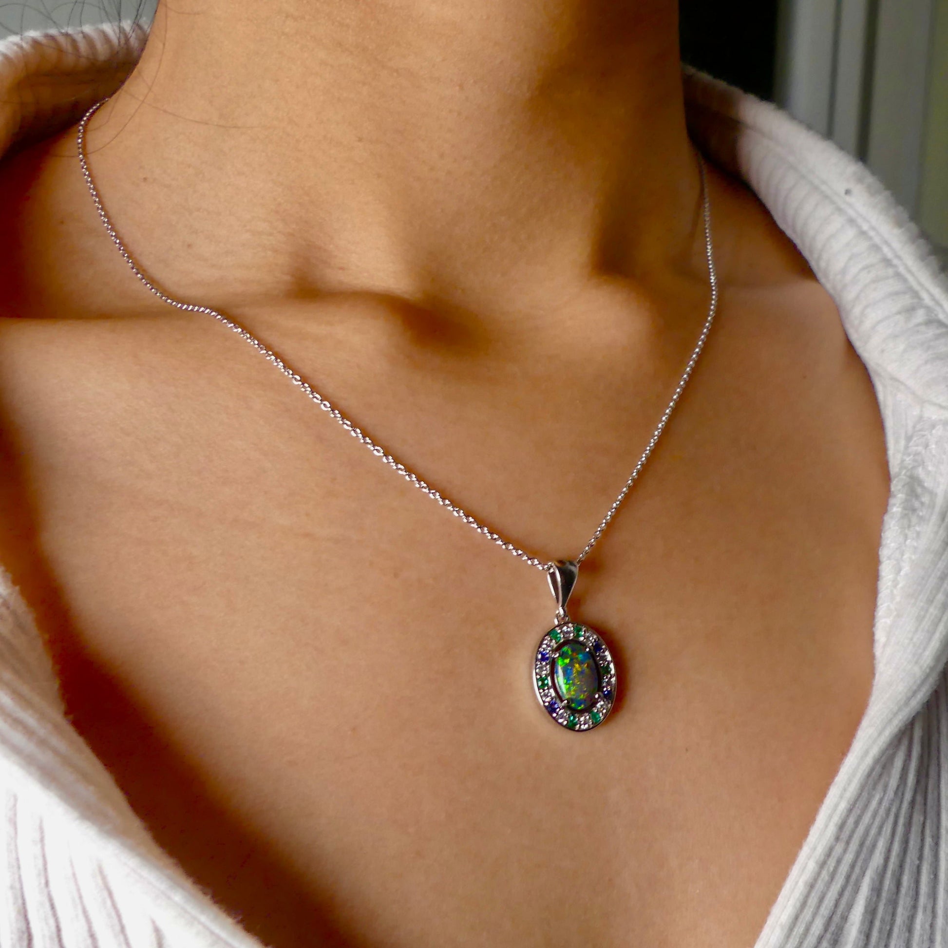 Lightning Ridge Australian black opal with strong, highly prized colors of reds, orange, and yellows is undoubtedly a remarkable gemstone. Expertly crafted from 18k white gold, this pendant showcases the mesmerizing beauty of an Australian black opal, surrounded by sparkling diamonds, emeralds, and sapphires. Exquisite in design and quality, this pendant is a luxurious addition to any jewelry collection. Elevate your style with this stunning piece.

Opal Weight- 1.1ct

Body Tone- N1 Australian Black