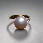 Expertly crafted and adorned with a lustrous South Sea pearl, this 14k gold ring exudes elegance and sophistication. Each pearl is hand-selected for its stunning size and natural colors, making each ring one-of-a-kind. Elevate any outfit with this timeless and luxurious piece.

Pearl- South Sea

Size- 11mm

Luster- AAA/AA

Setting- 14k Gold Handcrafted

Size- 7us

Handcrafted By Australian Artisans.
