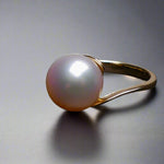 Expertly crafted and adorned with a lustrous South Sea pearl, this 14k gold ring exudes elegance and sophistication. Each pearl is hand-selected for its stunning size and natural colors, making each ring one-of-a-kind. Elevate any outfit with this timeless and luxurious piece.

Pearl- South Sea

Size- 11mm

Luster- AAA/AA

Setting- 14k Gold Handcrafted

Size- 7us

Handcrafted By Australian Artisans.
