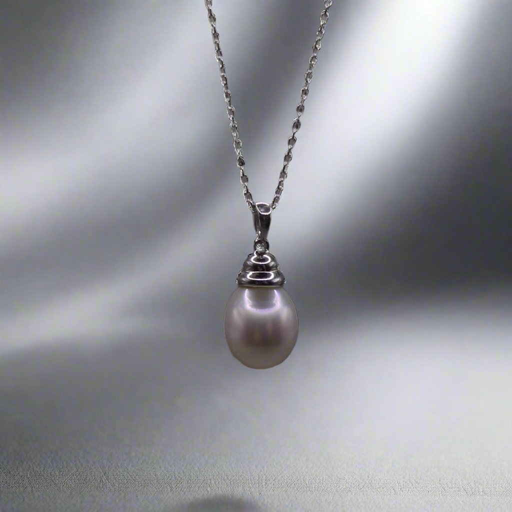 This beautiful sterling silver drop pearl pendant is the perfect addition to any jewelry collection. Made with high-quality materials, the elegant design exudes sophistication and grace. The lustrous South Sea pearl centerpiece adds a touch of luxury and can elevate any outfit. Enhance your style with this timeless accessory.

Pearl- South Sea Drop Pearl

Luster- AAA/AA

Size- 10mm

Setting- Sterling SIlver

Chain- Sterling Silver

Handcrafted By Australian Artisans
