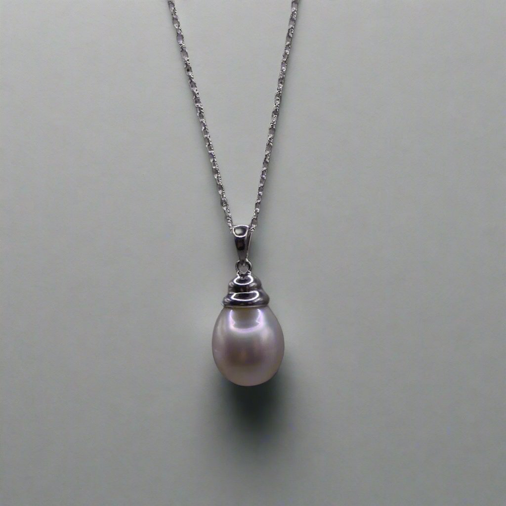 This beautiful sterling silver drop pearl pendant is the perfect addition to any jewelry collection. Made with high-quality materials, the elegant design exudes sophistication and grace. The lustrous South Sea pearl centerpiece adds a touch of luxury and can elevate any outfit. Enhance your style with this timeless accessory.

Pearl- South Sea Drop Pearl

Luster- AAA/AA

Size- 10mm

Setting- Sterling SIlver

Chain- Sterling Silver

Handcrafted By Australian Artisans
