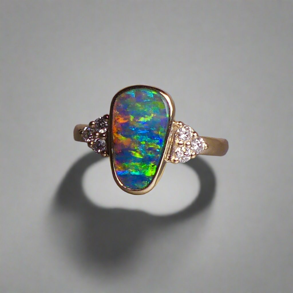 Expertly crafted, this stunning ring features a rare Australian gem boulder opal set in 14k gold and adorned with sparkling diamonds. The unique combination of precious materials and meticulous design makes this ring a one-of-a-kind piece, perfect for any special occasion or as a luxurious addition to any jewelry collection.

Origin- Queensland Australia

Opal Weight- 2.2ct Gem Australian Boulder Opal

Accent Stones- Natural Diamonds

Setting- 14K Gold Bezel Set

Size- 7 1/2 us
