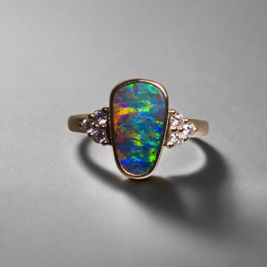 Expertly crafted, this stunning ring features a rare Australian gem boulder opal set in 14k gold and adorned with sparkling diamonds. The unique combination of precious materials and meticulous design makes this ring a one-of-a-kind piece, perfect for any special occasion or as a luxurious addition to any jewelry collection.

Origin- Queensland Australia

Opal Weight- 2.2ct Gem Australian Boulder Opal

Accent Stones- Natural Diamonds

Setting- 14K Gold Bezel Set

Size- 7 1/2 us

