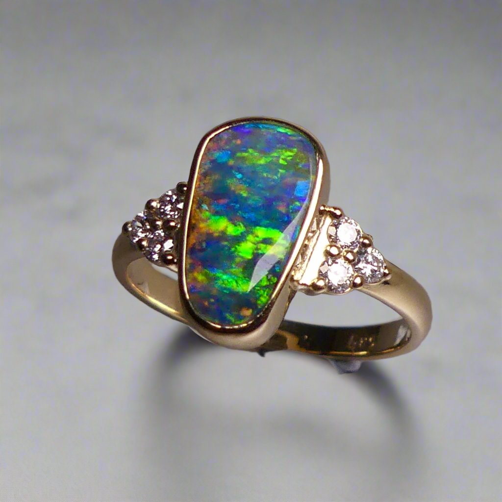 Expertly crafted, this stunning ring features a rare Australian gem boulder opal set in 14k gold and adorned with sparkling diamonds. The unique combination of precious materials and meticulous design makes this ring a one-of-a-kind piece, perfect for any special occasion or as a luxurious addition to any jewelry collection.

Origin- Queensland Australia

Opal Weight- 2.2ct Gem Australian Boulder Opal

Accent Stones- Natural Diamonds

Setting- 14K Gold Bezel Set

Size- 7 1/2 us
