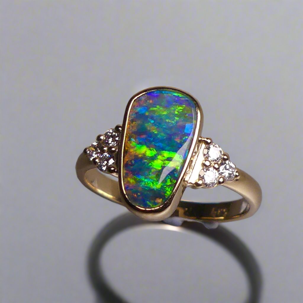 Expertly crafted, this stunning ring features a rare Australian gem boulder opal set in 14k gold and adorned with sparkling diamonds. The unique combination of precious materials and meticulous design makes this ring a one-of-a-kind piece, perfect for any special occasion or as a luxurious addition to any jewelry collection.

Origin- Queensland Australia

Opal Weight- 2.2ct Gem Australian Boulder Opal

Accent Stones- Natural Diamonds

Setting- 14K Gold Bezel Set

Size- 7 1/2 us
