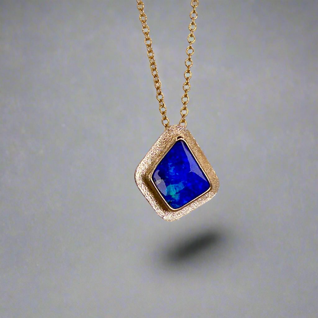 Expertly crafted, this Beautiful Australian Boulder Opal 18k Gold Pendant is a stunning piece of jewelry. Featuring a mesmerizing display of ocean blues and greens, this pendant is complemented by a solid 18k gold chain. Elevate any outfit with this unique and luxurious accessory.

Setting- 18k Gold bezel set

Opal Weight- 4.9ct

Origin- Queensland Australia

Chain- 18k gold cable chan, 45cm in Length

Expertly Handcrafted By Australian Artisans
