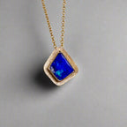 Expertly crafted, this Beautiful Australian Boulder Opal 18k Gold Pendant is a stunning piece of jewelry. Featuring a mesmerizing display of ocean blues and greens, this pendant is complemented by a solid 18k gold chain. Elevate any outfit with this unique and luxurious accessory.

Setting- 18k Gold bezel set

Opal Weight- 4.9ct

Origin- Queensland Australia

Chain- 18k gold cable chan, 45cm in Length

Expertly Handcrafted By Australian Artisans
