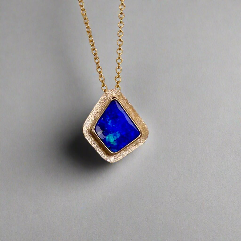 Expertly crafted, this Beautiful Australian Boulder Opal 18k Gold Pendant is a stunning piece of jewelry. Featuring a mesmerizing display of ocean blues and greens, this pendant is complemented by a solid 18k gold chain. Elevate any outfit with this unique and luxurious accessory.

Setting- 18k Gold bezel set

Opal Weight- 4.9ct

Origin- Queensland Australia

Chain- 18k gold cable chan, 45cm in Length

Expertly Handcrafted By Australian Artisans

