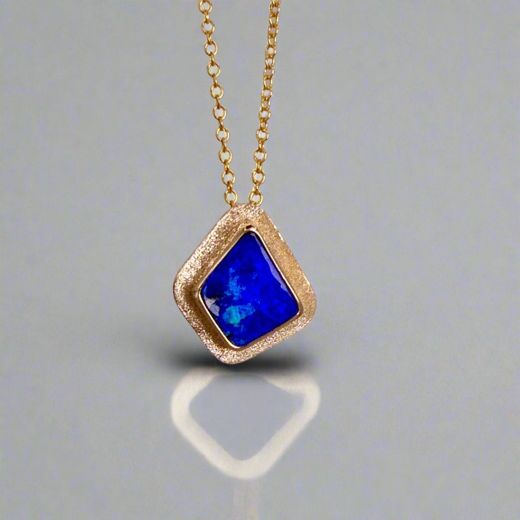 Expertly crafted, this Beautiful Australian Boulder Opal 18k Gold Pendant is a stunning piece of jewelry. Featuring a mesmerizing display of ocean blues and greens, this pendant is complemented by a solid 18k gold chain. Elevate any outfit with this unique and luxurious accessory.

Setting- 18k Gold bezel set

Opal Weight- 4.9ct

Origin- Queensland Australia

Chain- 18k gold cable chan, 45cm in Length

Expertly Handcrafted By Australian Artisans
