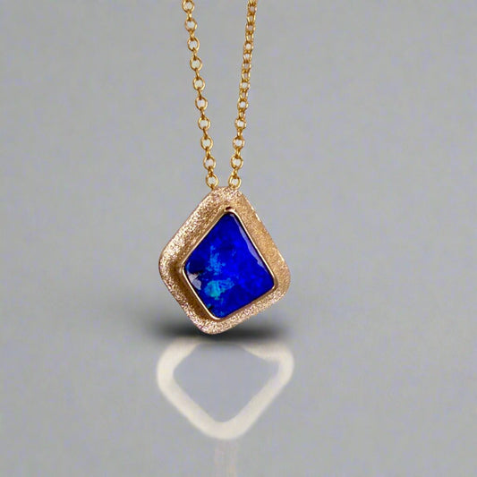 Expertly crafted, this Beautiful Australian Boulder Opal 18k Gold Pendant is a stunning piece of jewelry. Featuring a mesmerizing display of ocean blues and greens, this pendant is complemented by a solid 18k gold chain. Elevate any outfit with this unique and luxurious accessory.

Setting- 18k Gold bezel set

Opal Weight- 4.9ct

Origin- Queensland Australia

Chain- 18k gold cable chan, 45cm in Length

Expertly Handcrafted By Australian Artisans
