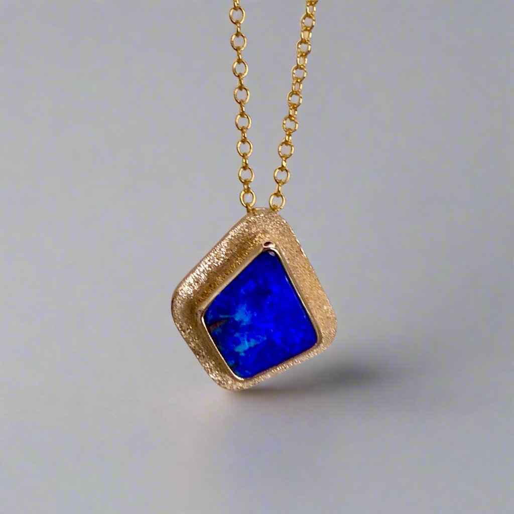 Expertly crafted, this Beautiful Australian Boulder Opal 18k Gold Pendant is a stunning piece of jewelry. Featuring a mesmerizing display of ocean blues and greens, this pendant is complemented by a solid 18k gold chain. Elevate any outfit with this unique and luxurious accessory.

Setting- 18k Gold bezel set

Opal Weight- 4.9ct

Origin- Queensland Australia

Chain- 18k gold cable chan, 45cm in Length

Expertly Handcrafted By Australian Artisans
