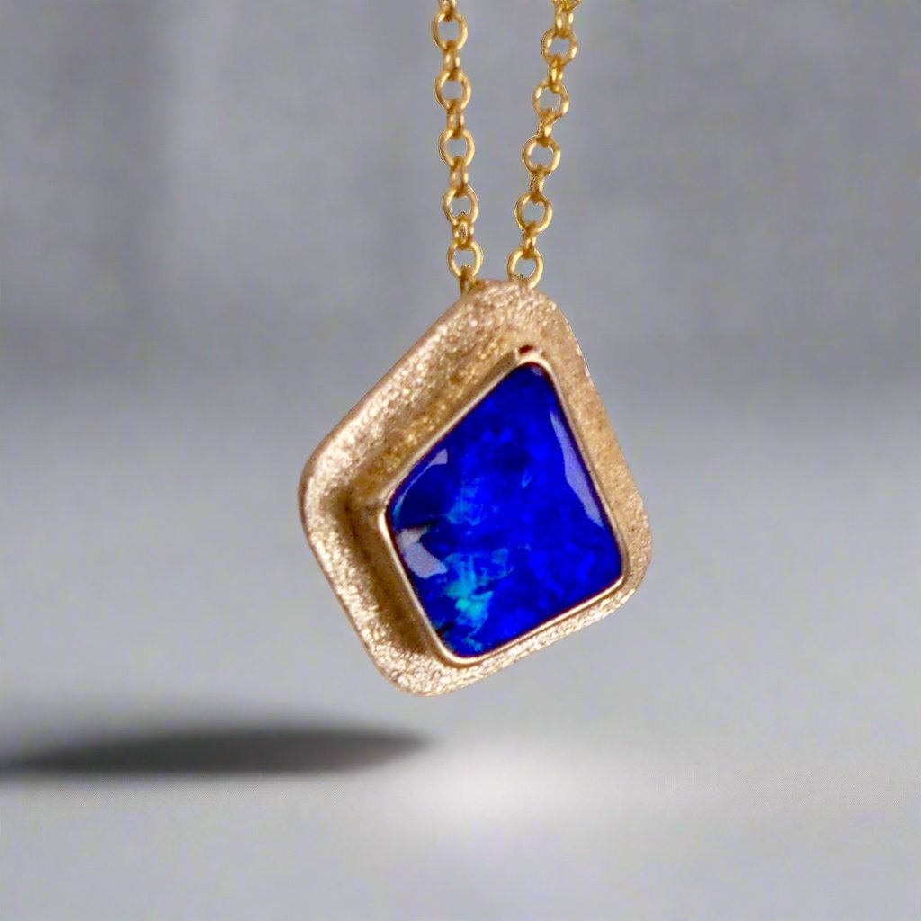 Expertly crafted, this Beautiful Australian Boulder Opal 18k Gold Pendant is a stunning piece of jewelry. Featuring a mesmerizing display of ocean blues and greens, this pendant is complemented by a solid 18k gold chain. Elevate any outfit with this unique and luxurious accessory.

Setting- 18k Gold bezel set

Opal Weight- 4.9ct

Origin- Queensland Australia

Chain- 18k gold cable chan, 45cm in Length

Expertly Handcrafted By Australian Artisans
