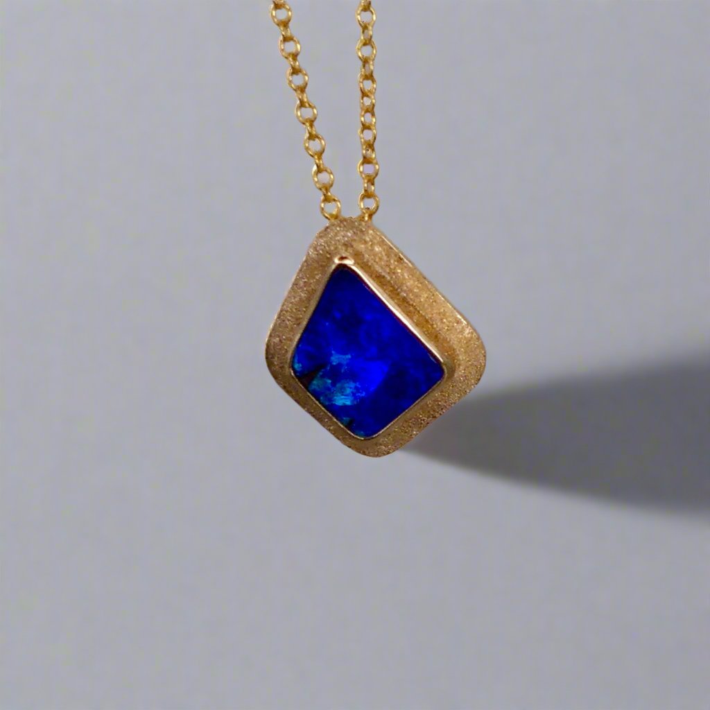 Expertly crafted, this Beautiful Australian Boulder Opal 18k Gold Pendant is a stunning piece of jewelry. Featuring a mesmerizing display of ocean blues and greens, this pendant is complemented by a solid 18k gold chain. Elevate any outfit with this unique and luxurious accessory.

Setting- 18k Gold bezel set

Opal Weight- 4.9ct

Origin- Queensland Australia

Chain- 18k gold cable chan, 45cm in Length

Expertly Handcrafted By Australian Artisans

