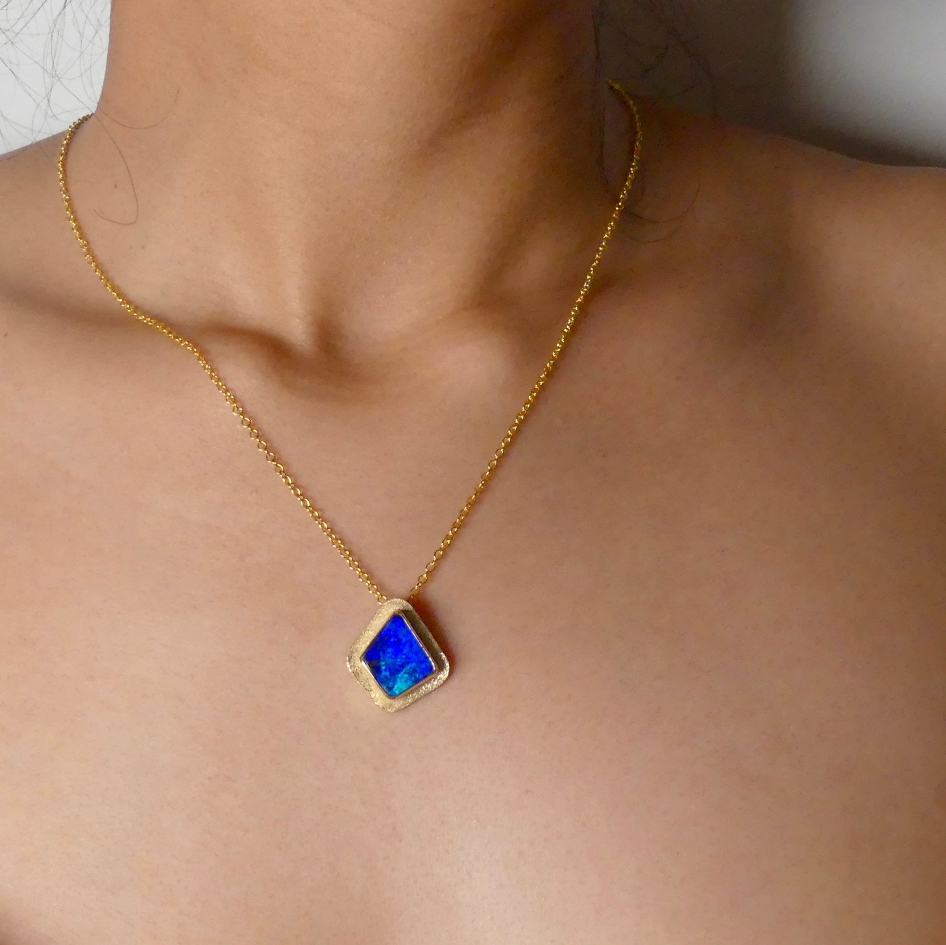 Expertly crafted, this Beautiful Australian Boulder Opal 18k Gold Pendant is a stunning piece of jewelry. Featuring a mesmerizing display of ocean blues and greens, this pendant is complemented by a solid 18k gold chain. Elevate any outfit with this unique and luxurious accessory.

Setting- 18k Gold bezel set

Opal Weight- 4.9ct

Origin- Queensland Australia

Chain- 18k gold cable chan, 45cm in Length

Expertly Handcrafted By Australian Artisans

