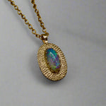 Experience the mesmerizing beauty of this 9k Gold Lightning Ridge Opal Pendant. Crafted with stunning crystal opal from the renowned Lightning Ridge mines, this pendant showcases a stunning array of blue and green hues.

Origin- Lightning Ridge Australia

Opal weight- 0.95ct Lightning Ridge Crystal Opal

Setting- 9K Gold

Chain- 9K gold cable chain, 45cm in length