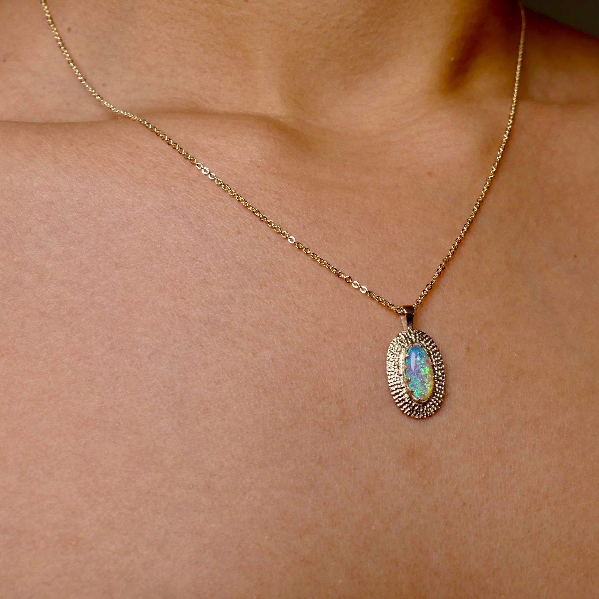 Experience the mesmerizing beauty of this 9k Gold Lightning Ridge Opal Pendant. Crafted with stunning crystal opal from the renowned Lightning Ridge mines, this pendant showcases a stunning array of blue and green hues.

Origin- Lightning Ridge Australia

Opal weight- 0.95ct Lightning Ridge Crystal Opal

Setting- 9K Gold

Chain- 9K gold cable chain, 45cm in length
