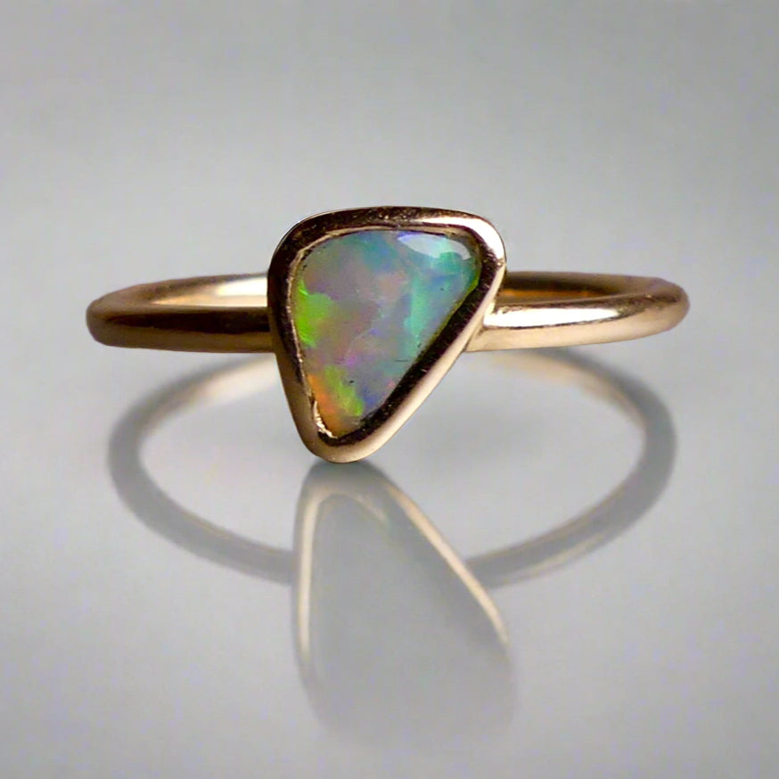 This Elegant 9ct Gold Ring is perfect for any occasion. Made with a stunning Crystal Opal from Lightning Ridge, displaying the full spectrum of colors, making it a unique and eye-catching piece. Its simple and elegant design adds a touch of sophistication to any outfit.

Origin- Lightning Ridge Australia

Opal- Australian Crystal Opal mined in Lightning Ridge Australia

Setting- 9ct solid Gold Bezel set

Size- 6 1/2 us

Designed and Handcrafted by skilled Australian Artisans
