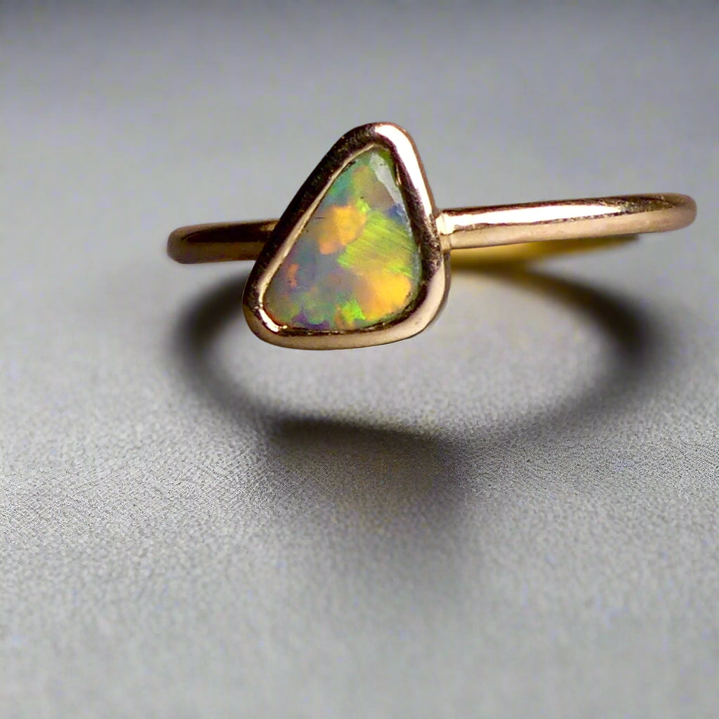 This Elegant 9ct Gold Ring is perfect for any occasion. Made with a stunning Crystal Opal from Lightning Ridge, displaying the full spectrum of colors, making it a unique and eye-catching piece. Its simple and elegant design adds a touch of sophistication to any outfit.

Origin- Lightning Ridge Australia

Opal- Australian Crystal Opal mined in Lightning Ridge Australia

Setting- 9ct solid Gold Bezel set

Size- 6 1/2 us

Designed and Handcrafted by skilled Australian Artisans
