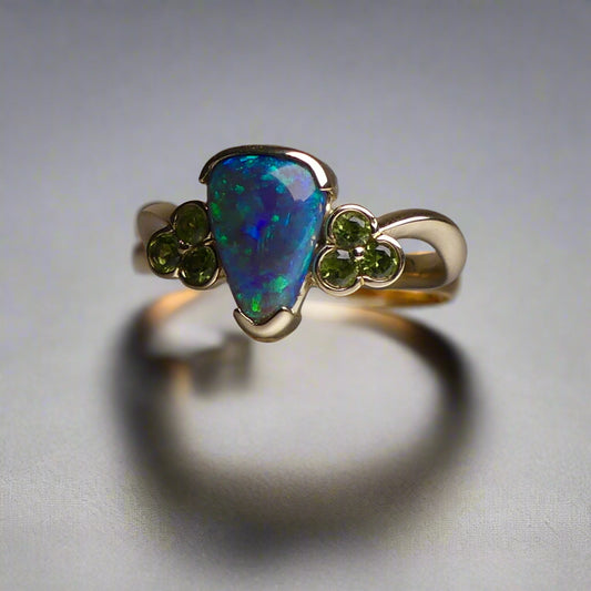 Indulge in timeless elegance with our 14k Australian Black Opal Ring. Crafted with a stunning black opal, this ring showcases mesmerizing blue and green colors. Each piece is unique, making it the perfect addition to any jewelry collection. Elevate your style with this timeless and luxurious ring.

Opal- 1.6ct Australian Black Opal

Origin-Lightning Ridge Australia

Setting- 14k Yellow Gold Bezel Set

Accent Stones- Forrest Green Sapphires

Size- 7 1/4 us
