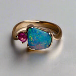Indulge in luxury with our Elegant 9k Gold Australian Boulder Opal Ring. This opulent piece displays a mesmerizing array of colors, making it a true statement of elegance. Handcrafted with the finest materials, this ring exudes sophistication and exclusivity. Elevate your style and add a touch of opulence to any outfit.

Opal- 2ct Australian Boulder Opal

Origin- Queensland Australia

Setting- 9k Gold Bezel Set

Accent Stone- Pink Tourmaline

Size- 7 1/2