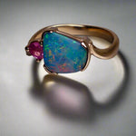 Indulge in luxury with our Elegant 9k Gold Australian Boulder Opal Ring. This opulent piece displays a mesmerizing array of colors, making it a true statement of elegance. Handcrafted with the finest materials, this ring exudes sophistication and exclusivity. Elevate your style and add a touch of opulence to any outfit.

Opal- 2ct Australian Boulder Opal

Origin- Queensland Australia

Setting- 9k Gold Bezel Set

Accent Stone- Pink Tourmaline

Size- 7 1/2