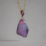 Add a touch of elegance to your jewelry collection with this stunning 9k gold Australian boulder opal pendant. The mesmerizing colors of the opal create a unique and beautiful piece that will surely turn heads. Perfect for everyday wear or special occasions, this pendant is a must-have for any opal lover. A timeless accessory that will elevate any outfit effortlessly.

Opal- 6.75ct Australian Boulder Opal

Origin- Queensland Australia

Setting- 9k Gold Bezel Set

Accent Stone- Pink Sapphire
