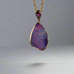 Add a touch of elegance to your jewelry collection with this stunning 9k gold Australian boulder opal pendant. The mesmerizing colors of the opal create a unique and beautiful piece that will surely turn heads. Perfect for everyday wear or special occasions, this pendant is a must-have for any opal lover. A timeless accessory that will elevate any outfit effortlessly.

Opal- 6.75ct Australian Boulder Opal

Origin- Queensland Australia

Setting- 9k Gold Bezel Set

Accent Stone- Pink Sapphire

