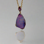 Add a touch of elegance to your jewelry collection with this stunning 9k gold Australian boulder opal pendant. The mesmerizing colors of the opal create a unique and beautiful piece that will surely turn heads. Perfect for everyday wear or special occasions, this pendant is a must-have for any opal lover. A timeless accessory that will elevate any outfit effortlessly.

Opal- 6.75ct Australian Boulder Opal

Origin- Queensland Australia

Setting- 9k Gold Bezel Set

Accent Stone- Pink Sapphire
