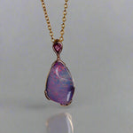 Add a touch of elegance to your jewelry collection with this stunning 9k gold Australian boulder opal pendant. The mesmerizing colors of the opal create a unique and beautiful piece that will surely turn heads. Perfect for everyday wear or special occasions, this pendant is a must-have for any opal lover. A timeless accessory that will elevate any outfit effortlessly.

Opal- 6.75ct Australian Boulder Opal

Origin- Queensland Australia

Setting- 9k Gold Bezel Set

Accent Stone- Pink Sapphire
