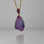 Add a touch of elegance to your jewelry collection with this stunning 9k gold Australian boulder opal pendant. The mesmerizing colors of the opal create a unique and beautiful piece that will surely turn heads. Perfect for everyday wear or special occasions, this pendant is a must-have for any opal lover. A timeless accessory that will elevate any outfit effortlessly.

Opal- 6.75ct Australian Boulder Opal

Origin- Queensland Australia

Setting- 9k Gold Bezel Set

Accent Stone- Pink Sapphire
