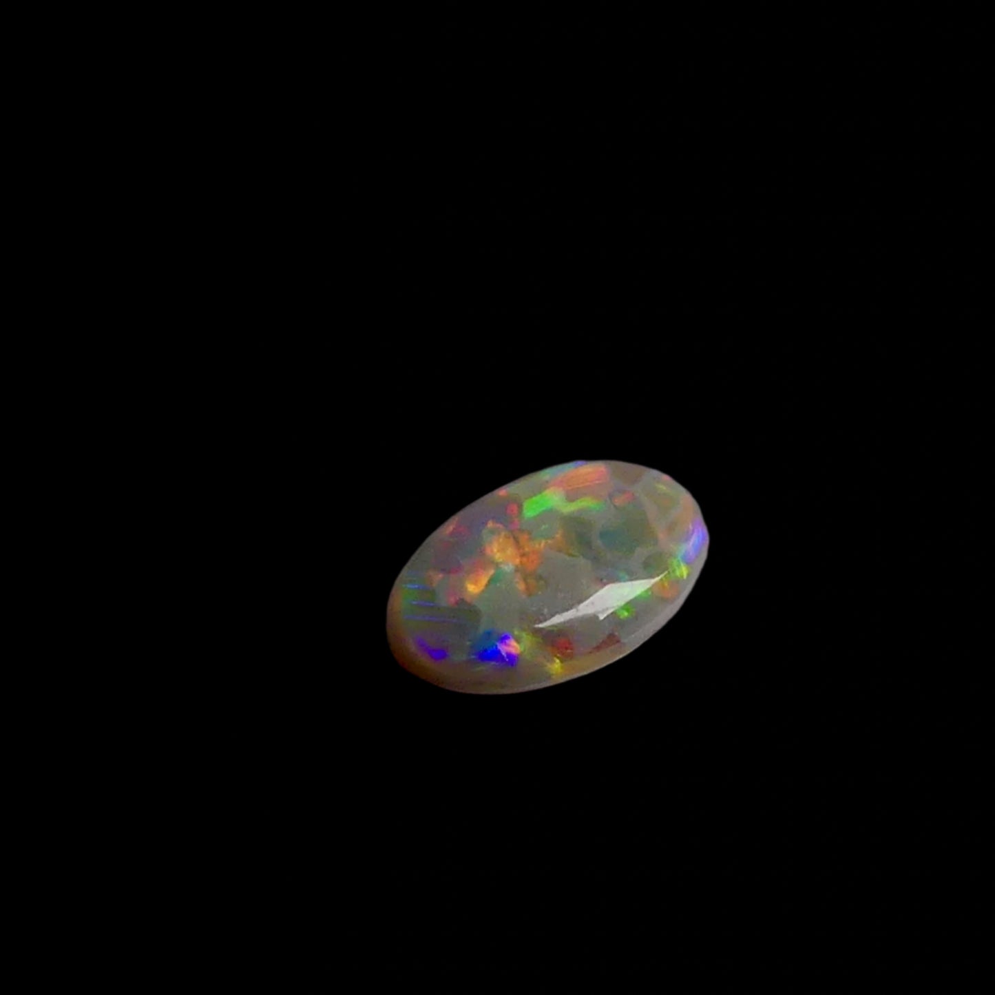 This 1.1ct Lightning Ridge Opal exhibits the distinctive pastel color spectrum that makes these Australian gems highly coveted. Expertly cut to enhance its natural play-of-light, this specimen displays delicate color transitions across its surface. The characteristic pastel palette demonstrates the superior quality typical of authentic Lightning Ridge material.
