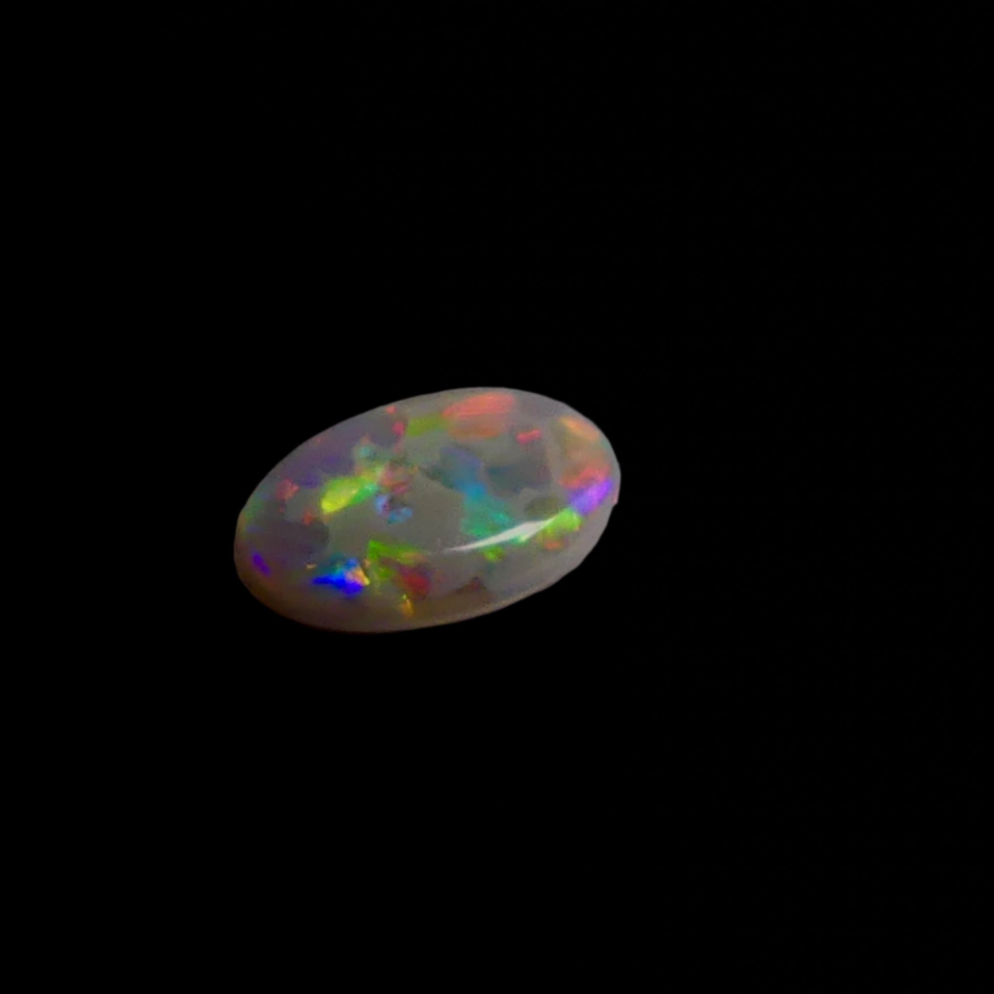 This 1.1ct Lightning Ridge Opal exhibits the distinctive pastel color spectrum that makes these Australian gems highly coveted. Expertly cut to enhance its natural play-of-light, this specimen displays delicate color transitions across its surface. The characteristic pastel palette demonstrates the superior quality typical of authentic Lightning Ridge material.
