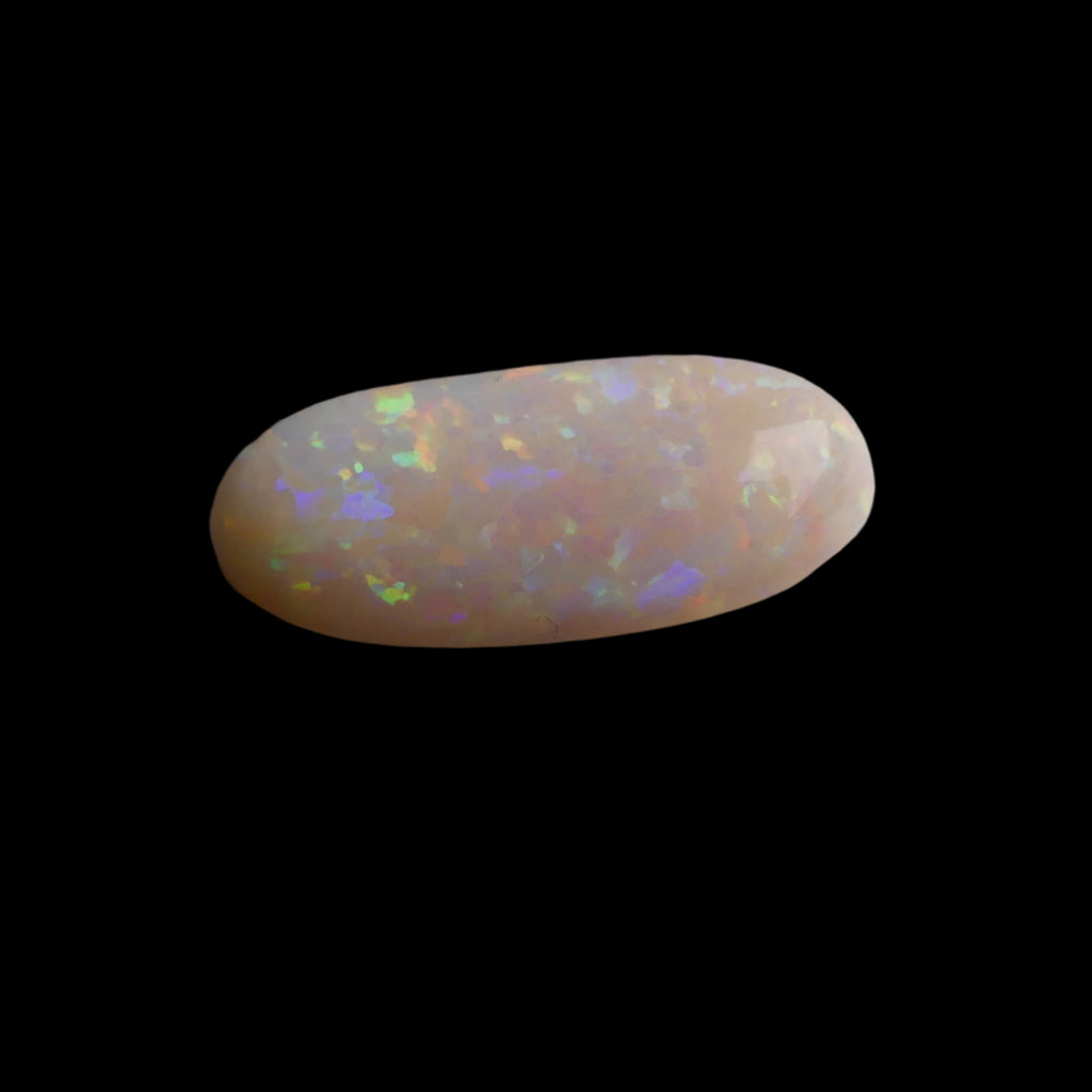 This extraordinary 6.4ct Coober Pedy Australian Opal showcases the legendary fire and brilliance that makes these gems so coveted worldwide. Mined from the renowned opal fields of South Australia, this unique specimen displays a mesmerizing play of colors that will captivate all who see it
