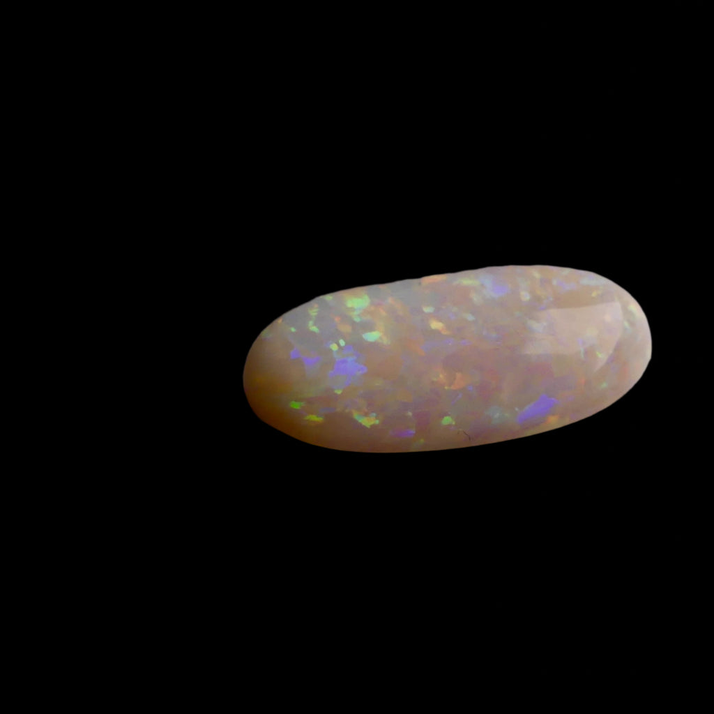 This extraordinary 6.4ct Coober Pedy Australian Opal showcases the legendary fire and brilliance that makes these gems so coveted worldwide. Mined from the renowned opal fields of South Australia, this unique specimen displays a mesmerizing play of colors that will captivate all who see it
