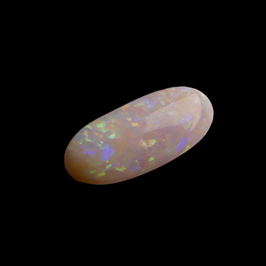 This extraordinary 6.4ct Coober Pedy Australian Opal showcases the legendary fire and brilliance that makes these gems so coveted worldwide. Mined from the renowned opal fields of South Australia, this unique specimen displays a mesmerizing play of colors that will captivate all who see it
