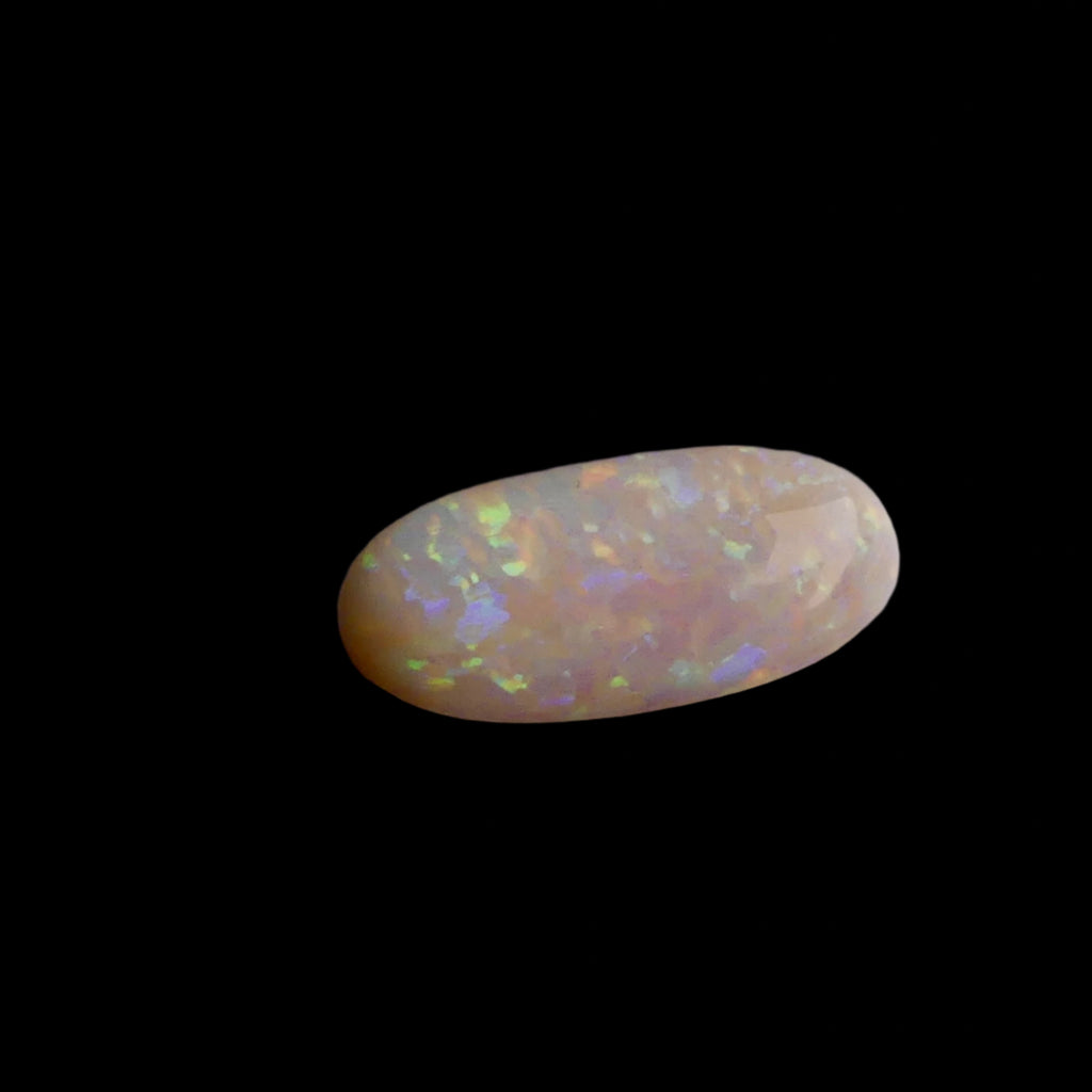 This extraordinary 6.4ct Coober Pedy Australian Opal showcases the legendary fire and brilliance that makes these gems so coveted worldwide. Mined from the renowned opal fields of South Australia, this unique specimen displays a mesmerizing play of colors that will captivate all who see it
