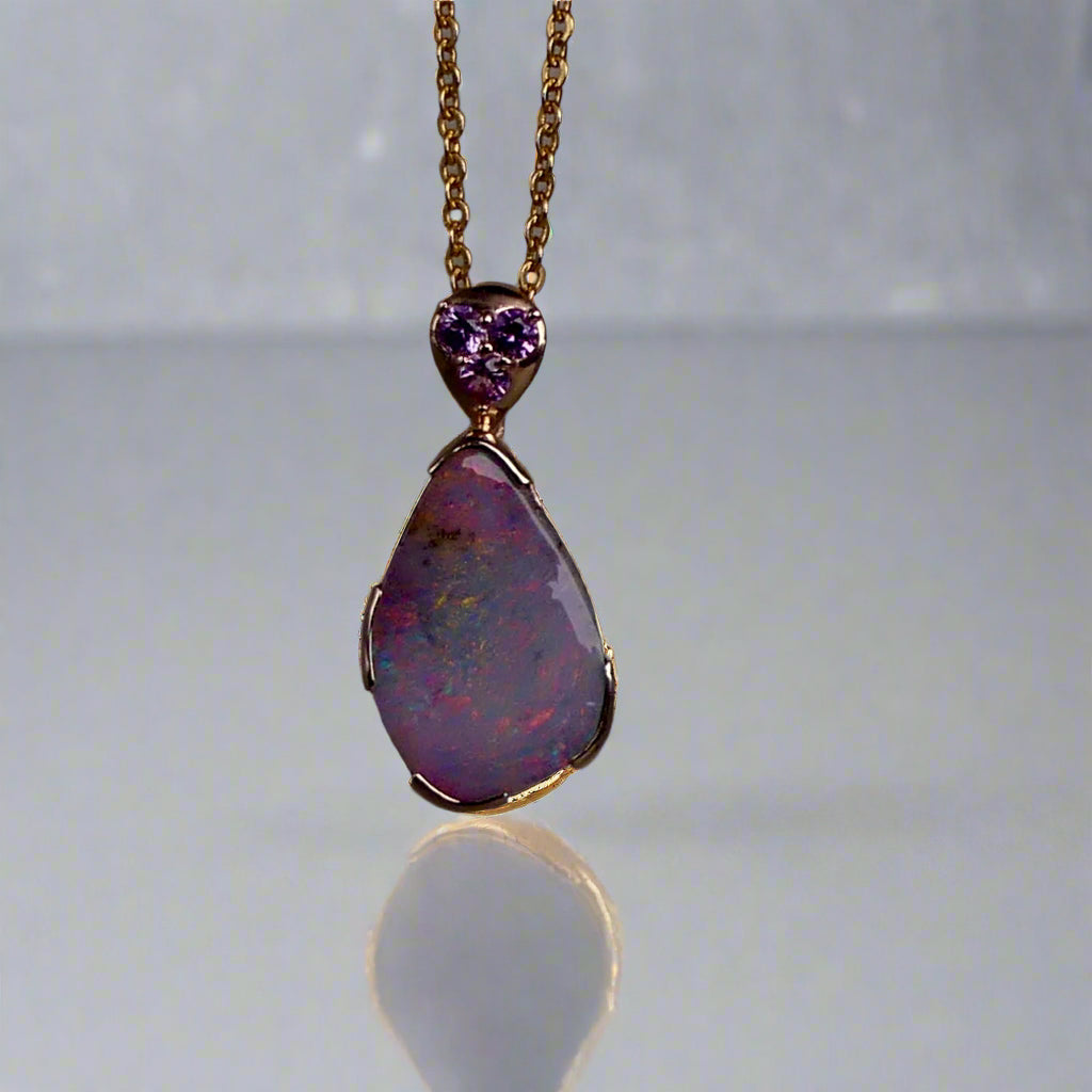 This exquisite 9k gold pendant features a genuine Australian Boulder Opal, showcasing vivid pink and green hues that captivate the eye. Expertly crafted to highlight the opal’s natural brilliance, this piece combines durability with elegant design, making it a timeless addition to any fine jewelry collection.