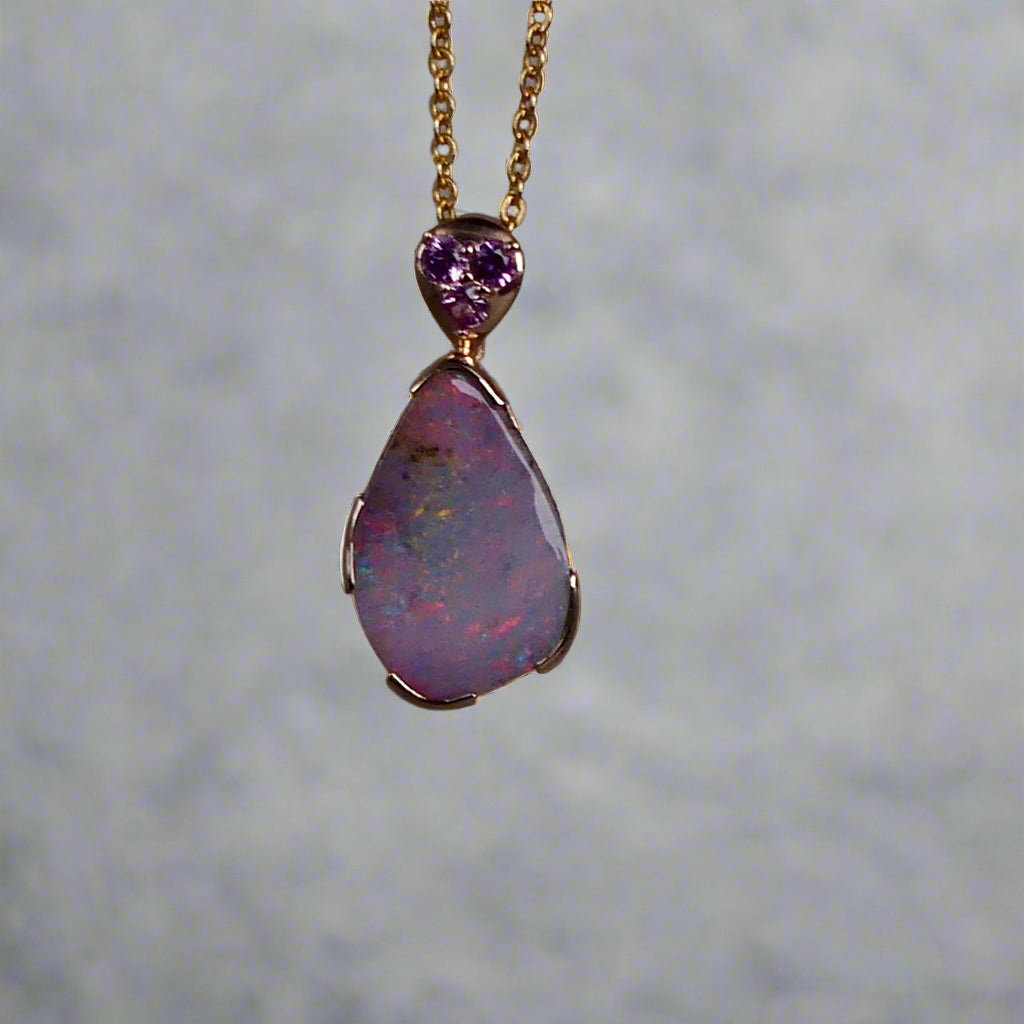 This exquisite 9k gold pendant features a genuine Australian Boulder Opal, showcasing vivid pink and green hues that captivate the eye. Expertly crafted to highlight the opal’s natural brilliance, this piece combines durability with elegant design, making it a timeless addition to any fine jewelry collection.
