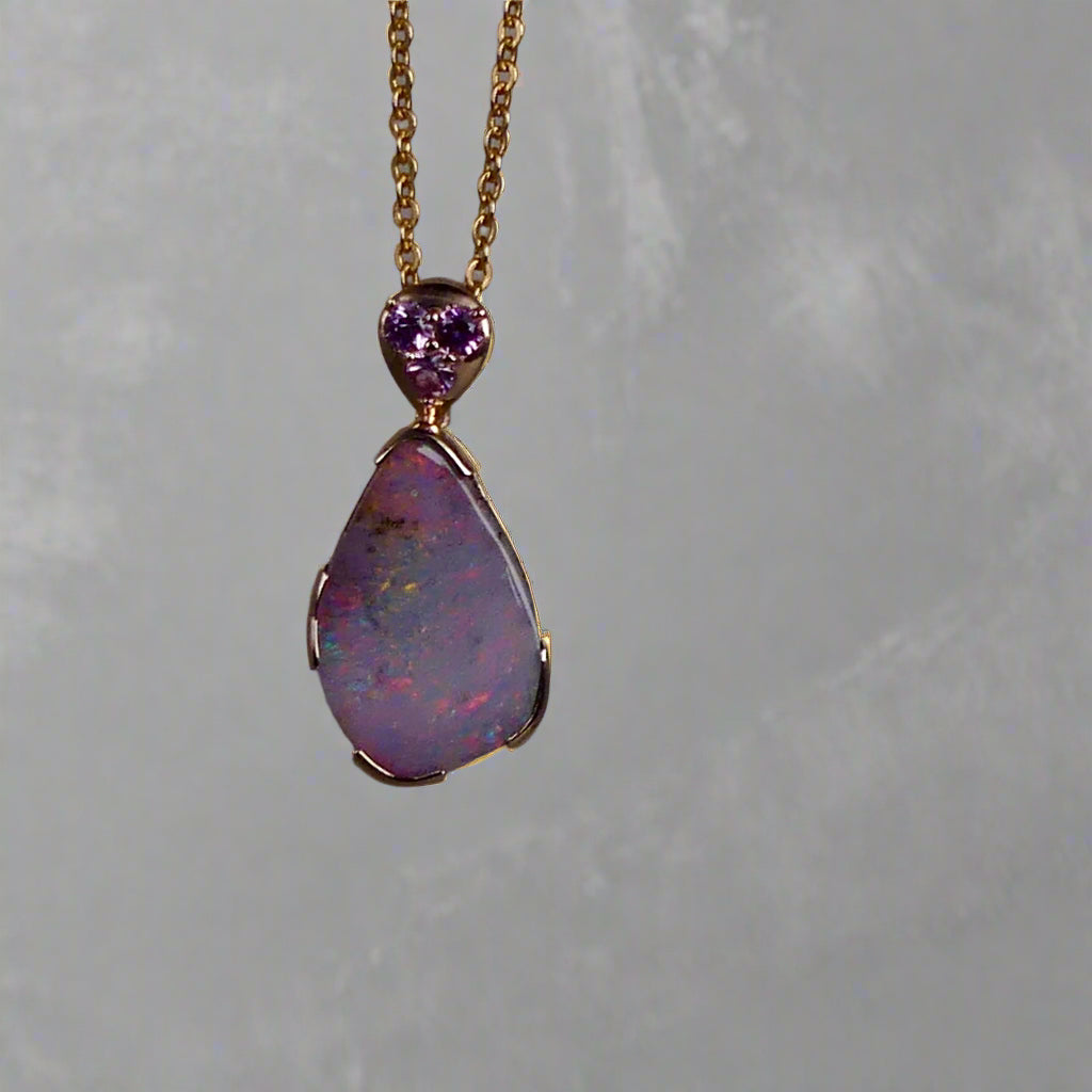 This exquisite 9k gold pendant features a genuine Australian Boulder Opal, showcasing vivid pink and green hues that captivate the eye. Expertly crafted to highlight the opal’s natural brilliance, this piece combines durability with elegant design, making it a timeless addition to any fine jewelry collection.