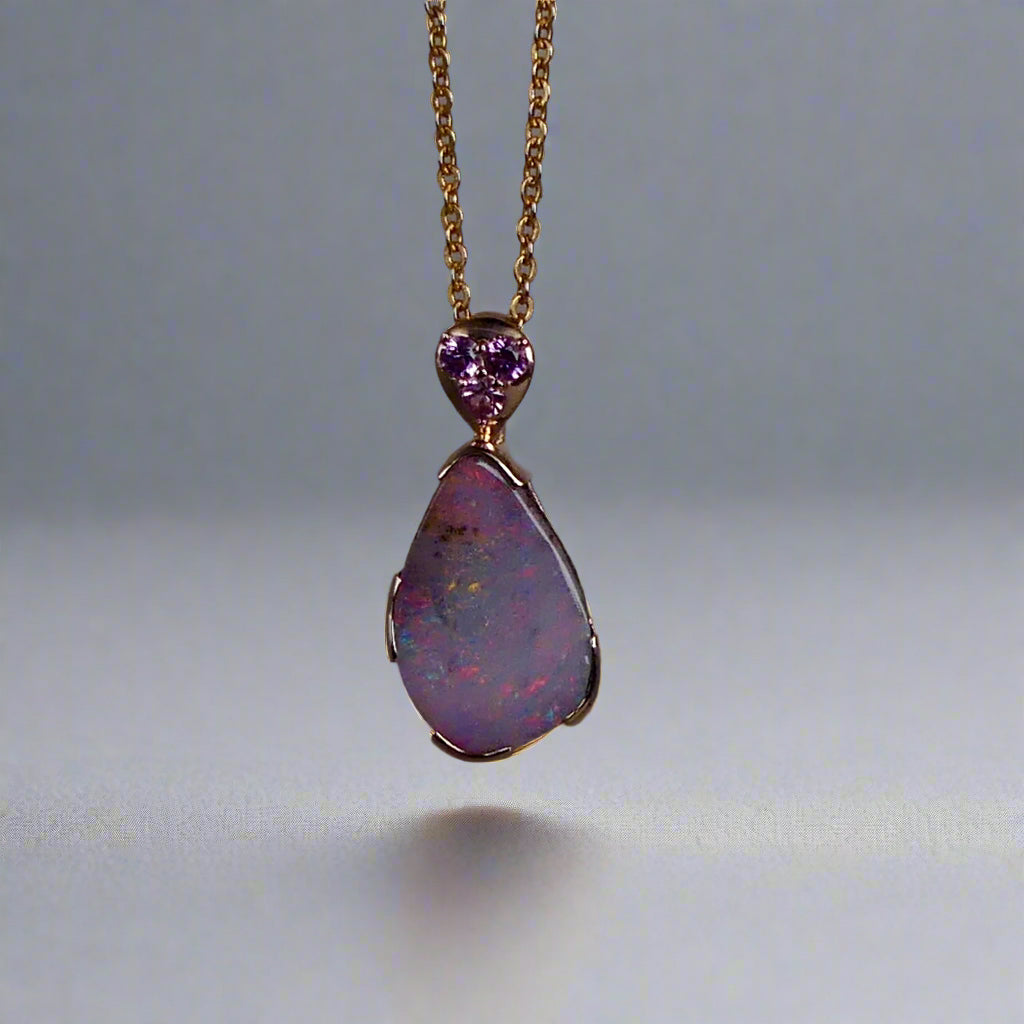 This exquisite 9k gold pendant features a genuine Australian Boulder Opal, showcasing vivid pink and green hues that captivate the eye. Expertly crafted to highlight the opal’s natural brilliance, this piece combines durability with elegant design, making it a timeless addition to any fine jewelry collection.