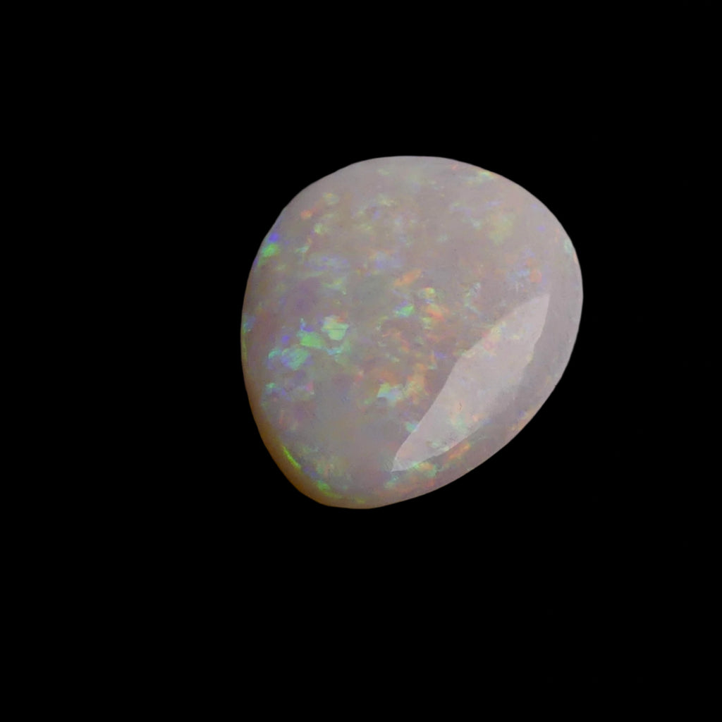 This 6.4-carat Cobber Pedy opal features delicate pastel patterns that showcase the gemstone’s unique play of color and fine Australian craftsmanship. Its subtle yet vibrant hues make it a distinguished choice for collectors and designers seeking an elegant and naturally captivating opal.