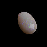 This 4.4-carat Coober Pedy opal displays a vibrant spectrum of colors, hallmark traits of this prestigious Australian opal. Expertly cut to highlight its natural brilliance, it offers a rare combination of size and quality.